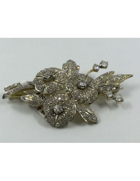 Broche en oro blanco y amarillo cuajado de brillantes.
