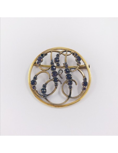 Broche de oro y piedras de color