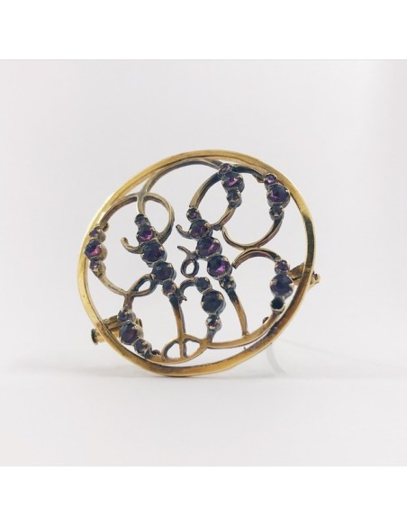 Broche de oro y piedras de color