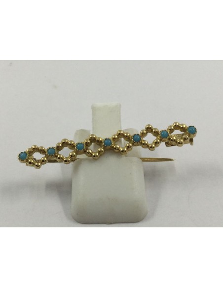 Broche aguja de oro y piedras azules