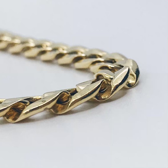 Cadena barbada plana en oro 18kt