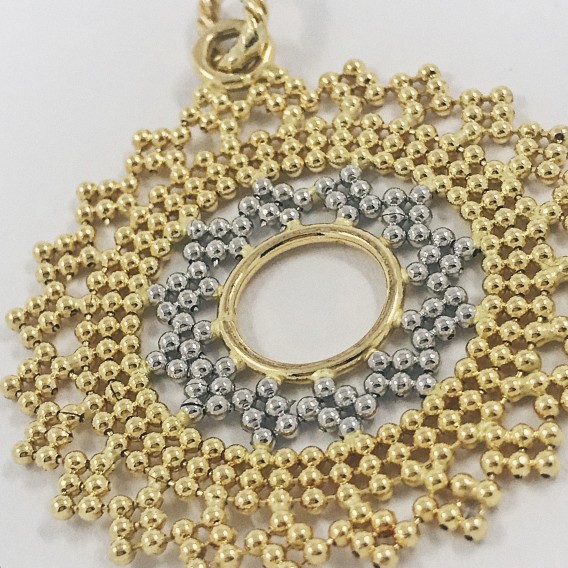 Colgante sol en oro blanco y amarillo.