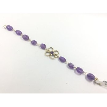 Pulsera de oro y  piedras color violeta.
